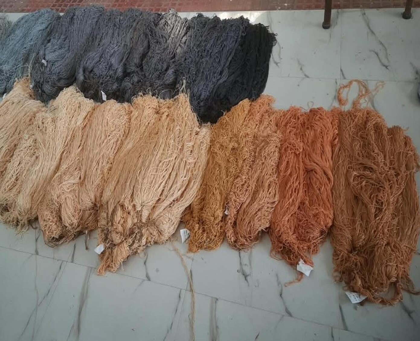 Undyed wool yarn hanks on the workshop table